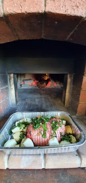 Pizza cooking in the wood-fired oven