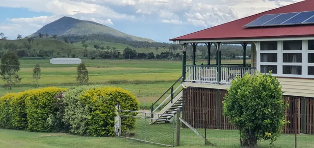 The farmhouse and mountain backdrop