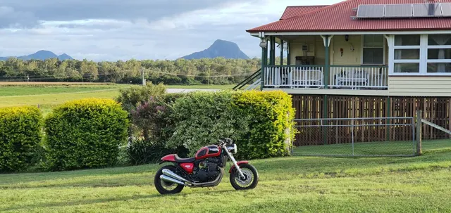 A motorcycle beside the farmhouse