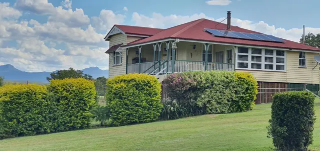 The farmhouse framed by green lawns