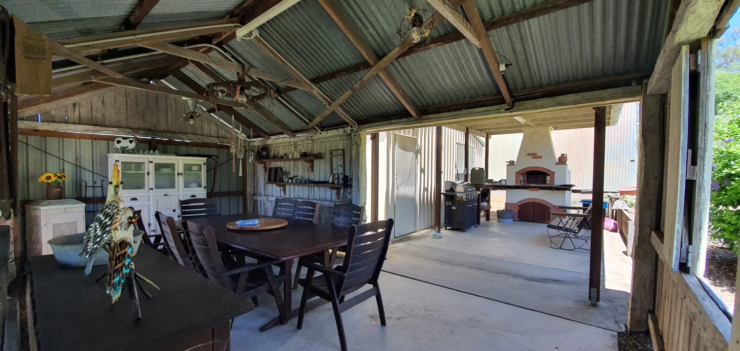 Rustic outdoor dining area and pizza oven